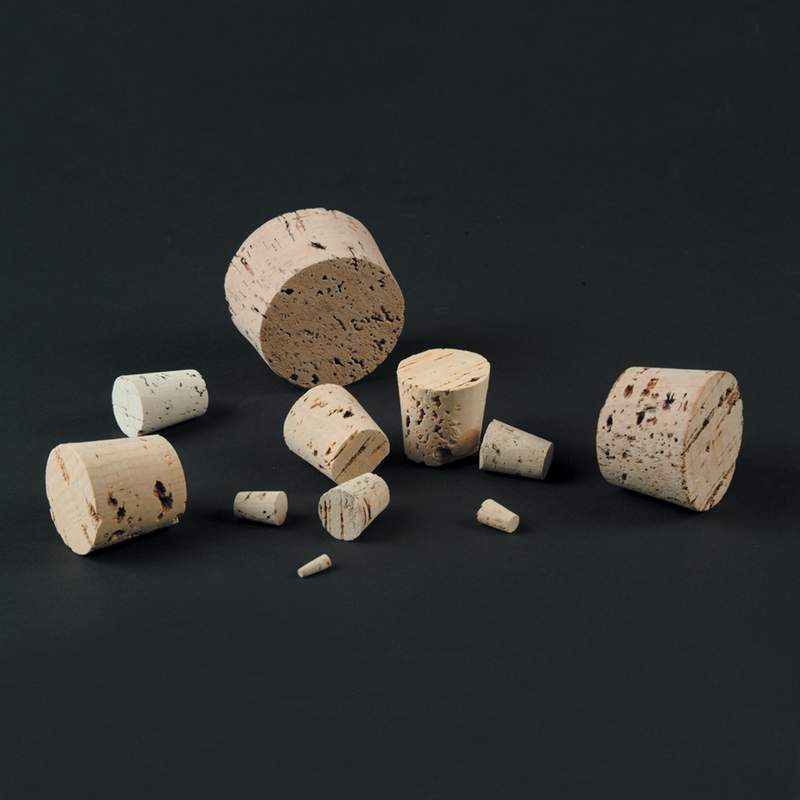 Assorted natural cork stoppers in various sizes scattered on a dark surface, ideal for kitchen and food storage, serving, and popular best-selling collections.