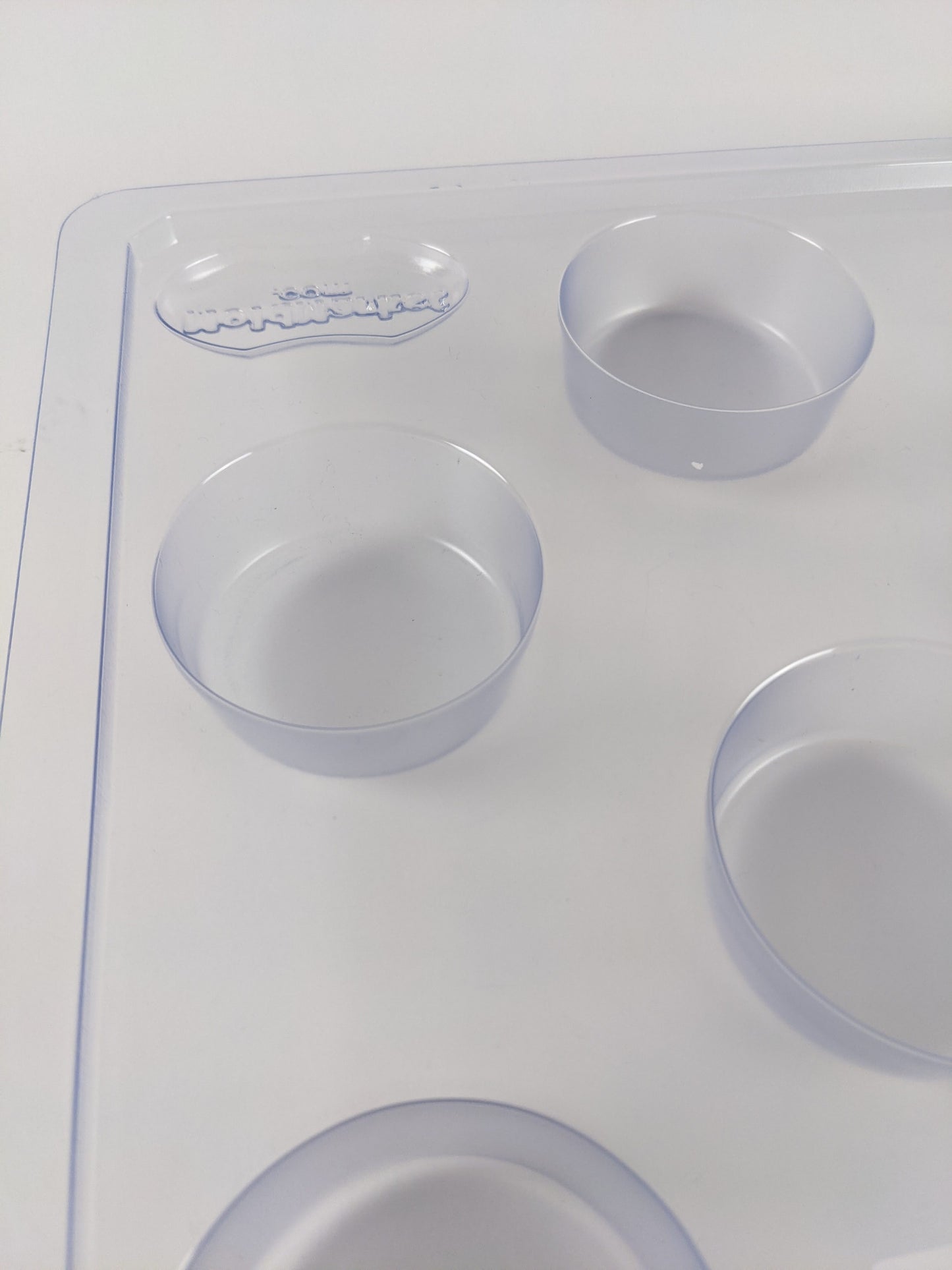 Clear plastic round soap mold with multiple cavities for creating 2.5 oz bars, designed for soapmaking enthusiasts and included in Health & Wellness and USA Made collections.