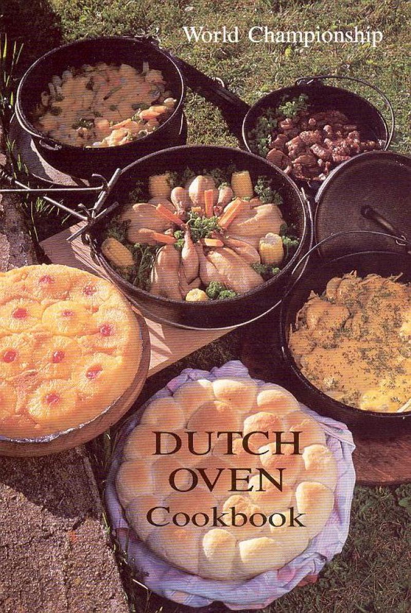 Outdoor setting displaying a variety of dishes cooked in handcrafted cast-iron Dutch ovens, including breads, vegetables, and meats, highlighting rustic cooking techniques featured in cookbooks collections.