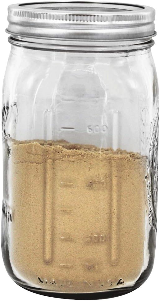 Clear wide-mouth quart jar with metal lid, partially filled with brown powder, handcrafted and made in USA, suited for Kitchen & Food, Food Preservation, and Canning collections.