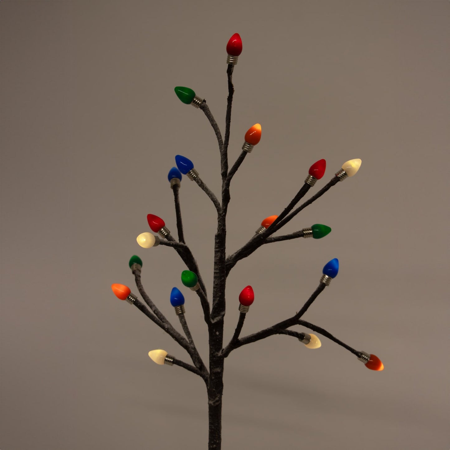 Handcrafted holiday tree with slender branches and vibrant colored bulb caps in red, green, blue, orange, and white, perfect for Home & Decor, Holiday Decor, Best Sellers, and Promo Eligible collections.
