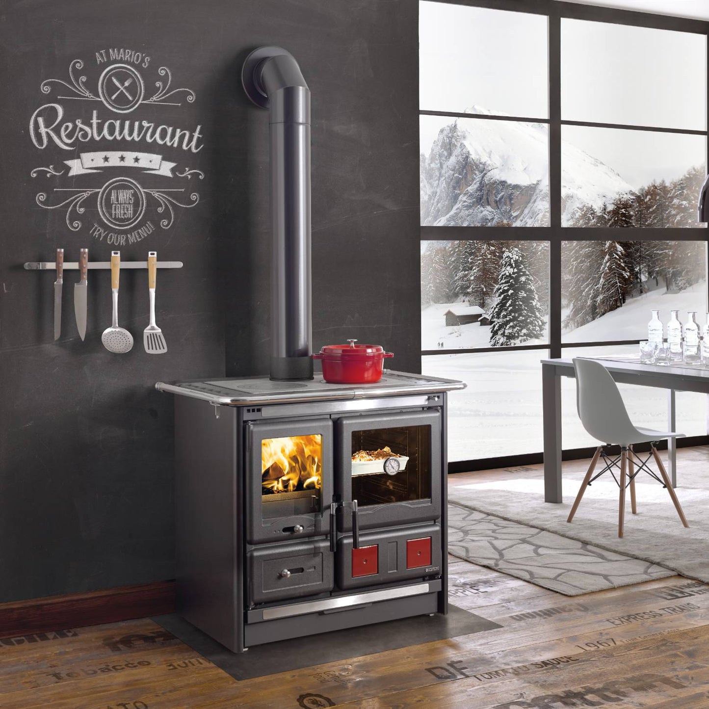 Steel wood-burning cook stove with polished cooking surface, dual glass doors showing fire and oven, removable ash drawer, and cast iron hearth, featured in Stoves and Cookstoves collections.