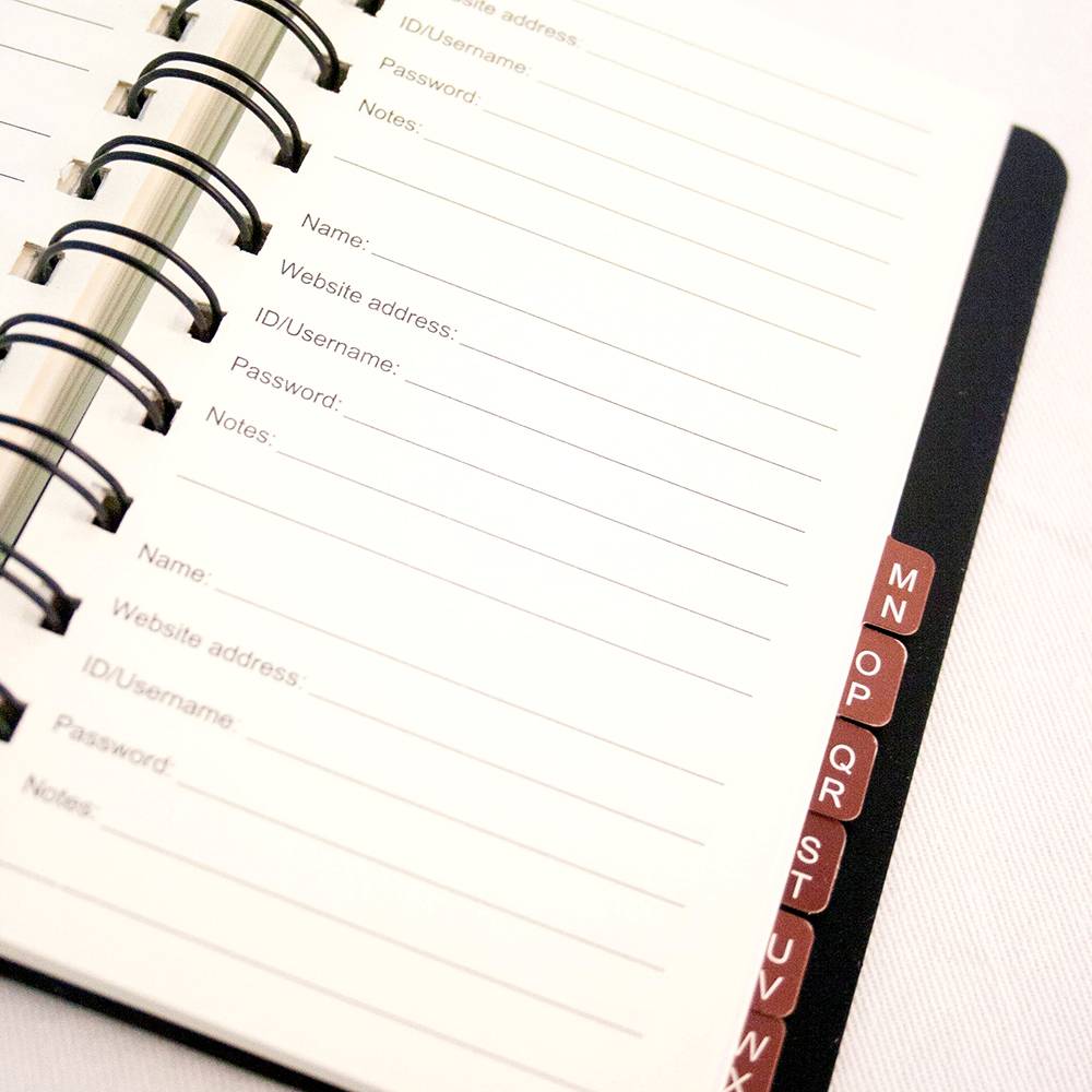 Close-up of spiral-bound Internet password organizer featuring alphabetical tabs from M to W and lined pages to record website names, usernames, passwords, and notes, ideal for Home & Decor and Household Helpers collections.