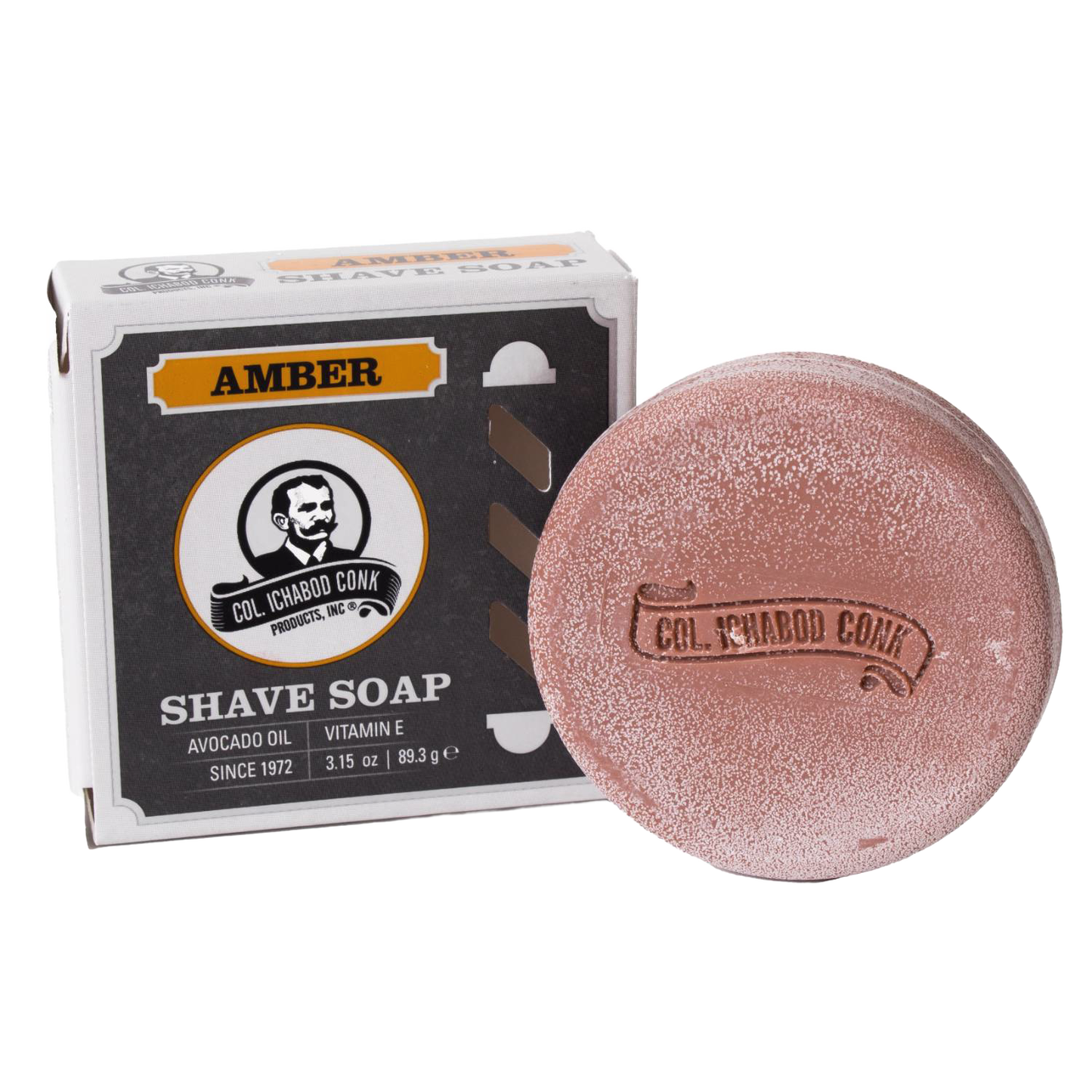 Amber-colored shaving soap puck with embossed branding alongside its box featuring vintage design, containing avocado oil and vitamin E, ideal for Health & Wellness and Grooming collections.