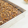 Recycled steel rectangular pan with corrugated surface for even baking of moist desserts, topped with chopped pecans, ideal for Kitchen & Food, Cookware, Baking Supplies, and USA Made collections.