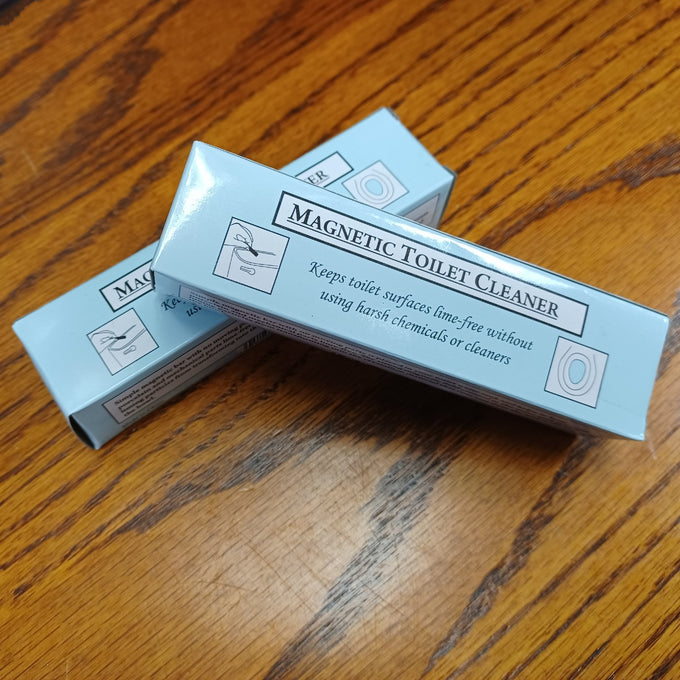 Stack of light blue boxes labeled magnetic toilet cleaner, advertised as keeping toilet surfaces free from lime without harsh chemicals, displayed on a wooden surface, featured in Home & Decor and Household Cleaning collections.