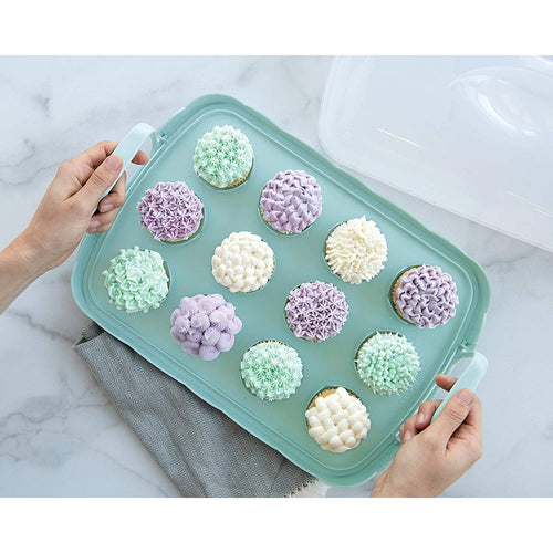 A reversible cake and cupcake carrier with scalloped red edging and snap-lock handles holds 12 pastel-decorated cupcakes on a light blue tray, made in USA for Kitchen & Food and Baking Supplies collections.