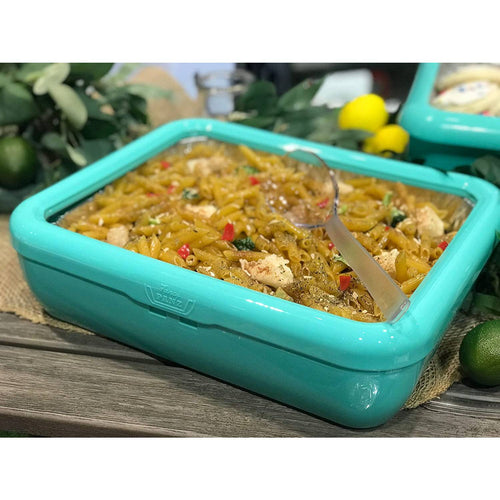 Turquoise Fancy Panz cover securely fitting a foil pan filled with seasoned pasta and chicken, highlighting Kitchen & Food and USA Made collections with a clear removable window for easy serving.