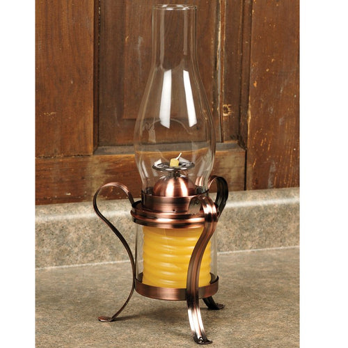 Handcrafted hurricane candle lamp with a copper-finished metal frame and a beeswax coil, featuring a clear glass chimney for safe, adjustable lighting in lamps and candles collections.