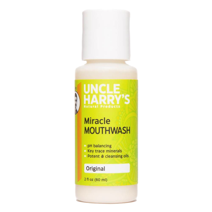 Small white plastic bottle of natural mouthwash with a bright yellow and green label featuring pH balancing and mineral benefits, suitable for Health & Wellness and Grooming collections.