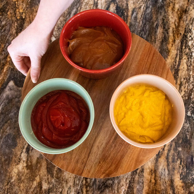 Handcrafted 12-inch wooden Lazy Susan turntable with three ceramic condiment bowls in red, green, and beige filled with sauces, ideal for Kitchen & Food, Storage and Serving collections.