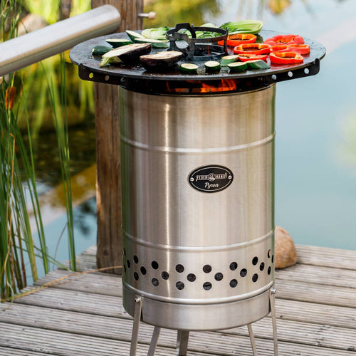 Stainless steel outdoor cooking device with a solid steel plate grilling colorful vegetables over open flames, perfect for Farm, Garden & Tool, Camping, Best Sellers, and Promo Eligible collections.