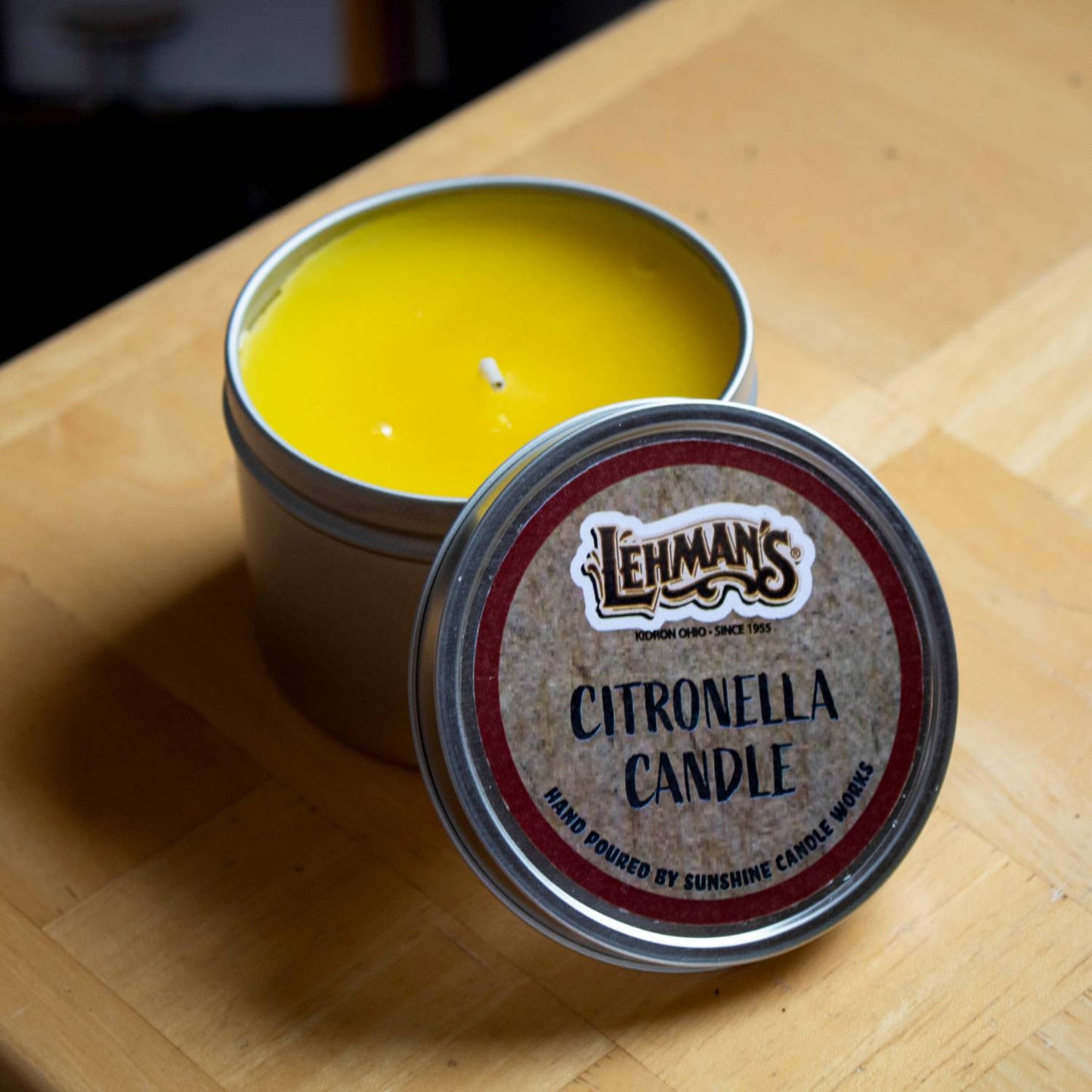 Hand-poured, handcrafted citronella candle in a lightweight metal tin with bright yellow wax, designed to repel mosquitoes for outdoor use in camping, pest control, and garden lighting collections.