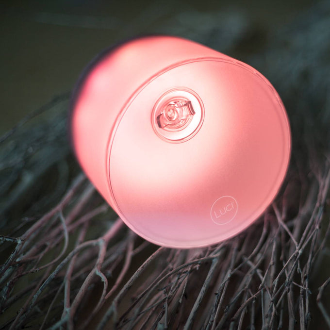 Inflatable solar LED light glowing with soft pink hue, featuring a compact design with valve for easy inflation, ideal for camping, emergency supplies, and outdoor Farm & Garden use.