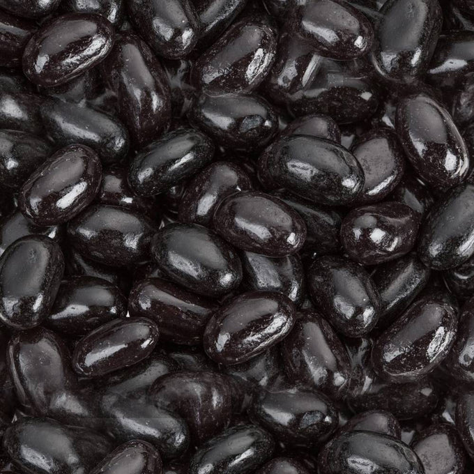 Close-up view of glossy jumbo black licorice jelly beans, showcasing their smooth texture and deep black color, featured in Kitchen & Food and Snacks and Sweets collections.