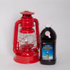 Bright red handcrafted metal oil lantern with clear glass globe and visible wick, next to a black plastic bottle of citronella fuel, suited for Farm, Garden & Tool, Camping, and Pest Control collections.