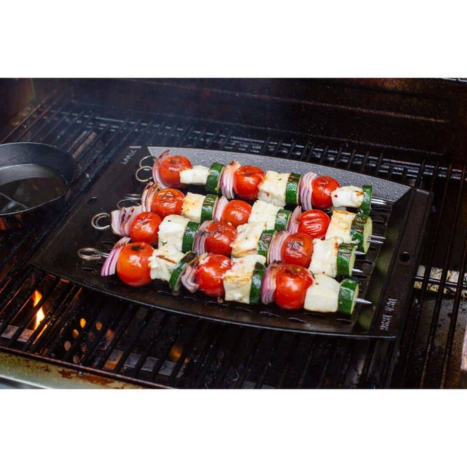 Handcrafted cast iron grill topper pan with signature perforated design, loaded with colorful vegetable and cheese skewers, perfect for Kitchen & Food and Cast Iron collections.