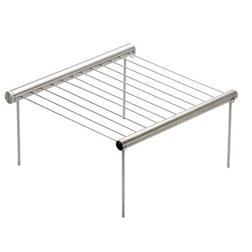Compact stainless steel portable grill with foldable legs and parallel grilling rods, designed for quick setup and easy cleaning, ideal for camping and outdoor grilling.