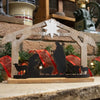 Handcrafted wooden nativity display with weathered stable and star, featuring black metal silhouettes of the Holy Family and animals, perfect for Home & Decor and Holiday Decor collections.