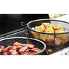 Two black metal grilling baskets on an outdoor gas grill cooking seasoned chicken wings and mixed vegetables including corn, tomatoes, and onions, ideal for versatile grilling in cookware and grilling collections.