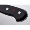 Close-up of a black handle with two metal rivets and a red logo on a premium chef’s knife, highlighting its sturdy full tang design for kitchen and food prep use.
