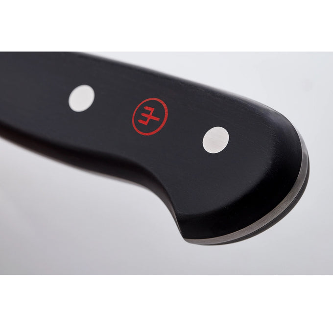 Close-up of a black handle with two metal rivets and a red logo on a premium chef’s knife, highlighting its sturdy full tang design for kitchen and food prep use.