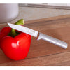 Handcrafted serrated paring knife with a finely serrated high carbon surgical stainless steel blade and solid aluminum handle piercing a red bell pepper on a wooden cutting board, made in USA, ideal for Farm, Garden & Tool, Kitchen & Food, and Knives & Axes collections.