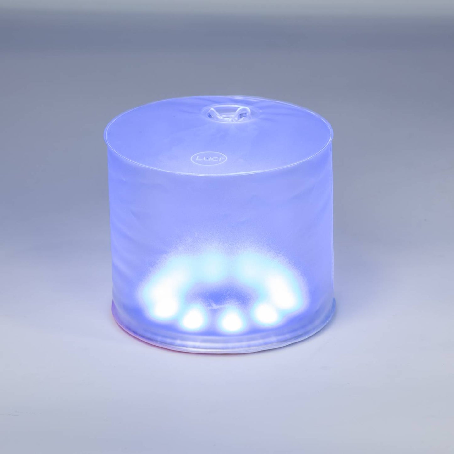 Soft blue illuminated inflatable LED solar light with compact, portable design ideal for camping, emergency preparedness, and outdoor farm, garden & tool lighting.