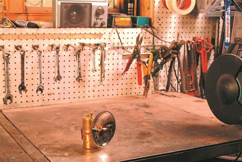 Handcrafted solid brass carbide lamp with striker, providing bright white light ideal for camping and outdoor use, featured in Lamps & Lighting and Camping collections.