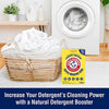 Laundry room scene showing a front-loading washing machine, a wicker basket filled with white laundry, and a box of natural laundry booster positioned on light hardwood floor, ideal for Household Cleaning and Laundry Supplies collections.