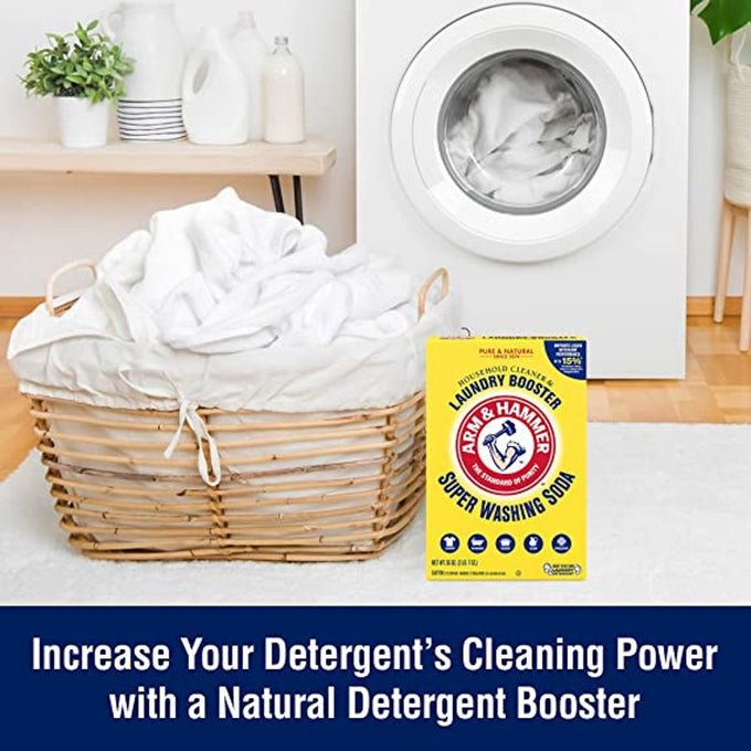 Laundry room scene showing a front-loading washing machine, a wicker basket filled with white laundry, and a box of natural laundry booster positioned on light hardwood floor, ideal for Household Cleaning and Laundry Supplies collections.