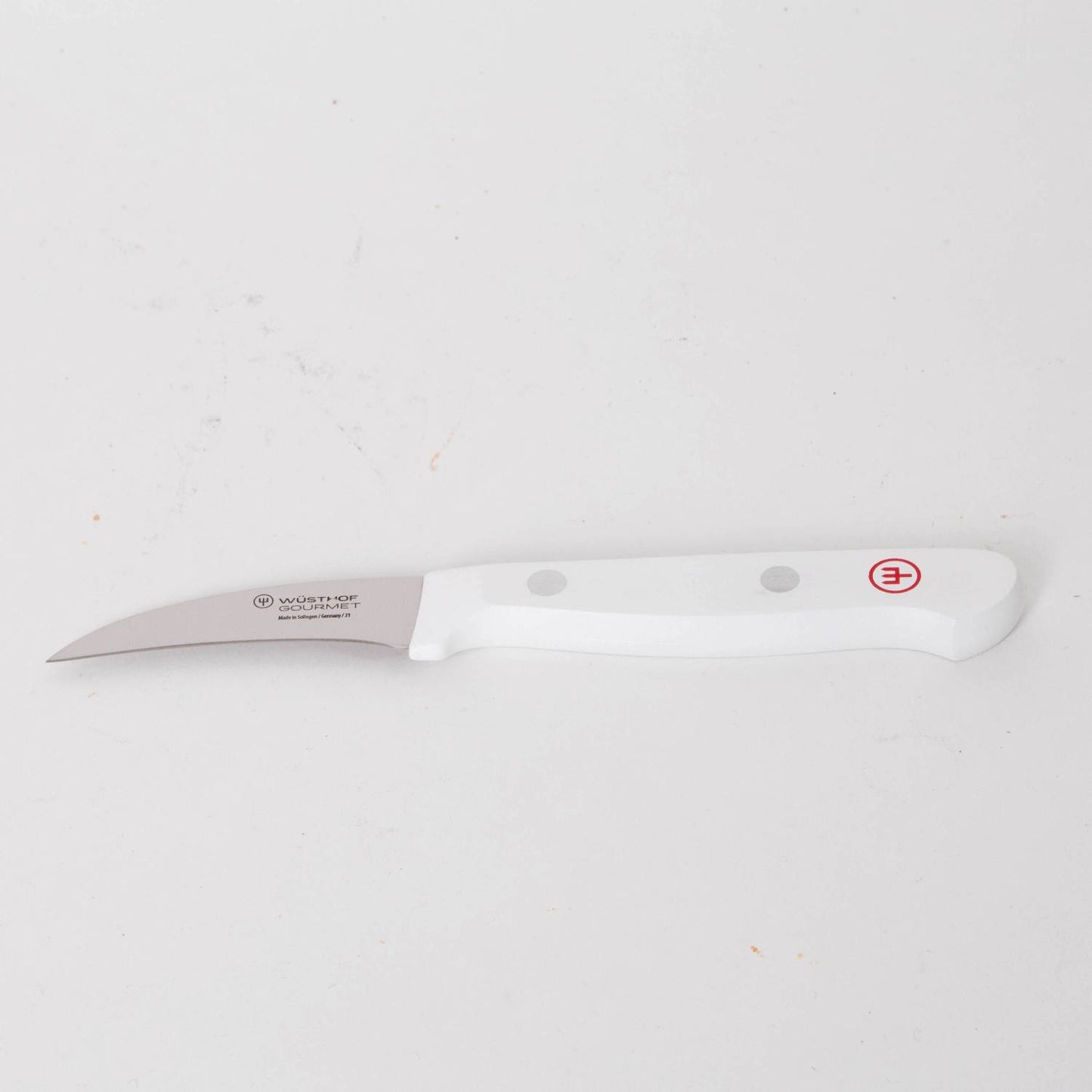 Curved paring knife with a stainless steel blade and ergonomic white handle featuring rivet accents, designed for detailed food prep in Kitchen & Food and Food Prep collections.