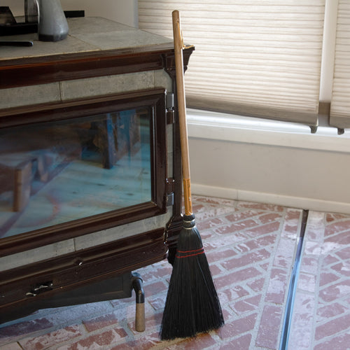Handcrafted Amish-made fireplace broom with natural corn straw bristles and a 20-inch wooden handle, ideal for cleaning ashes, featured in hearth accessories and USA made collections.