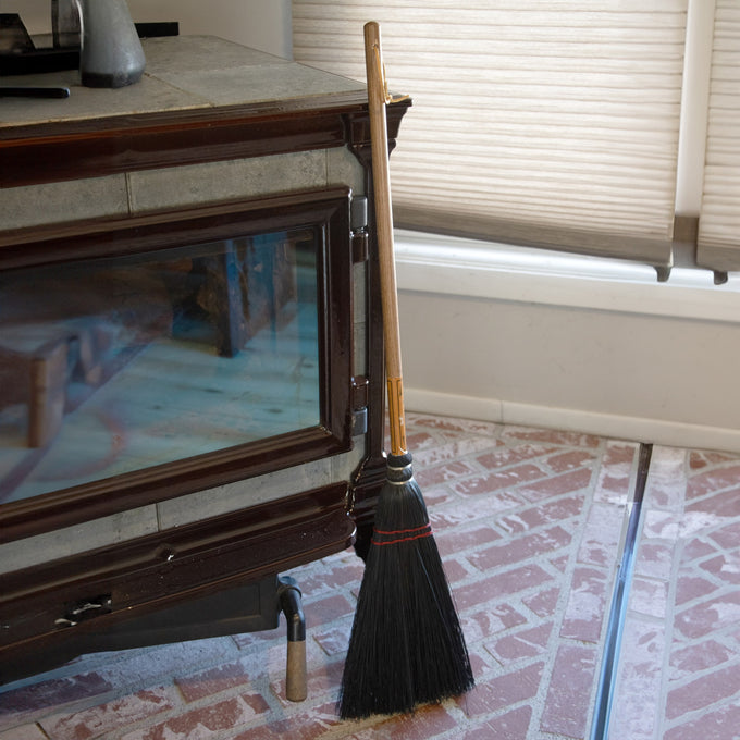 Handcrafted Amish-made fireplace broom with natural corn straw bristles and a 20-inch wooden handle, ideal for cleaning ashes, featured in hearth accessories and USA made collections.