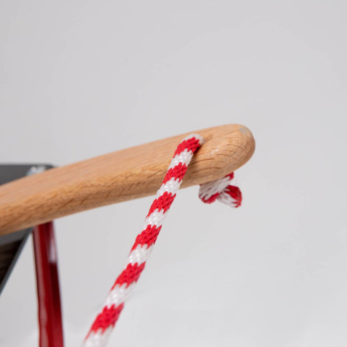 Close-up of a smooth oak wood handle with red and white braided rope, showcasing handcrafted Amish made detail from a sturdy outdoor play sled in Toys, Books & Games and USA Made collections.