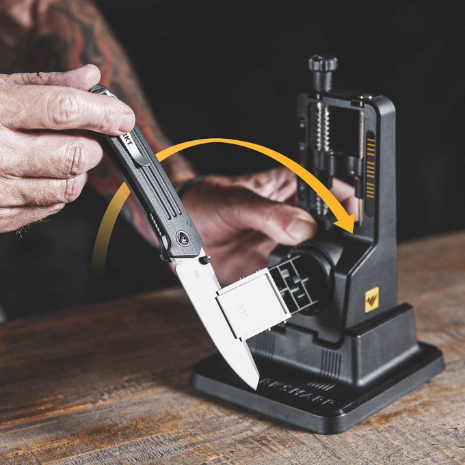 Hand adjusting a folding knife blade into a precision angle sharpening system with adjustable settings, ideal for use in Farm, Garden & Tool, Kitchen & Food, and Sharpening collections.