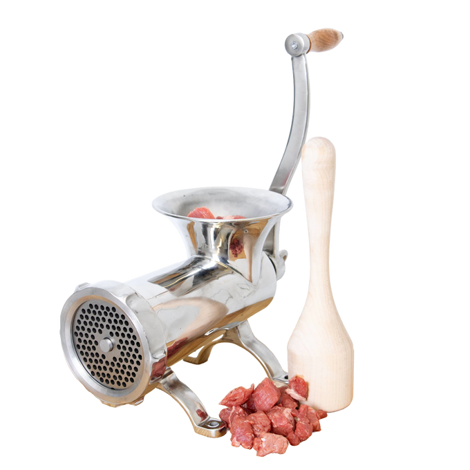 Shiny metal meat grinder with a smoothly sanded wooden stomper beside fresh red meat chunks, highlighting handcrafted Amish made specialty equipment for kitchen and food use.