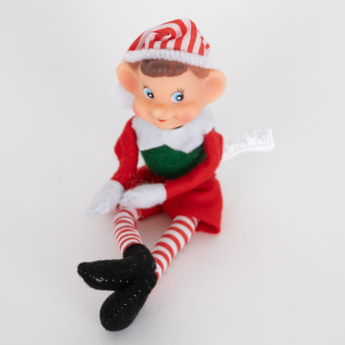 Handcrafted posable pixie elf in vintage style with red and green fabric outfit, striped red and white tights, and black felt shoes, ideal for Home & Decor and Holiday Decor collections.
