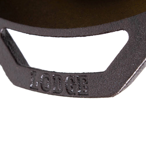 Close-up of a black cast iron skillet handle embossed with the brand name, showcasing durable construction ideal for Kitchen & Food, Cookware, Cast Iron, USA Made, and Best Sellers collections.