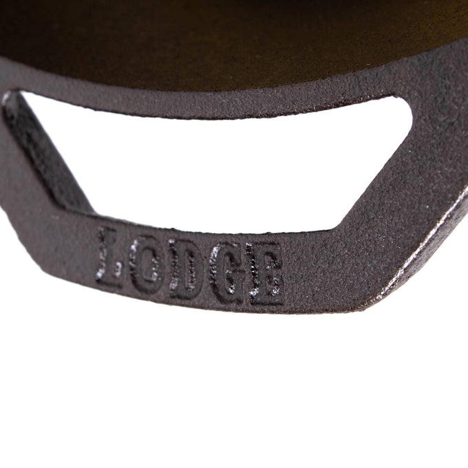 Close-up of a black cast iron skillet handle embossed with the brand name, showcasing durable construction ideal for Kitchen & Food, Cookware, Cast Iron, USA Made, and Best Sellers collections.