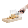 Handcrafted wooden bread slicing guide with clear acrylic panels ensuring even slices, shown in use with a serrated knife cutting fresh bread, ideal for Kitchen & Food and Baking collections.