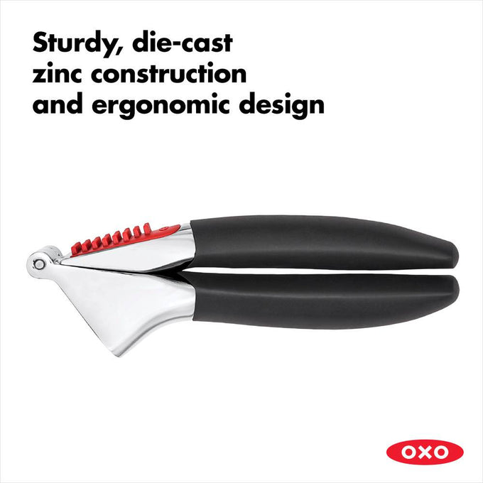 Garlic press with sturdy die-cast zinc body and ergonomic black handles featuring red accents, designed for comfortable use in Kitchen & Food and Kitchen Gadgets collections.