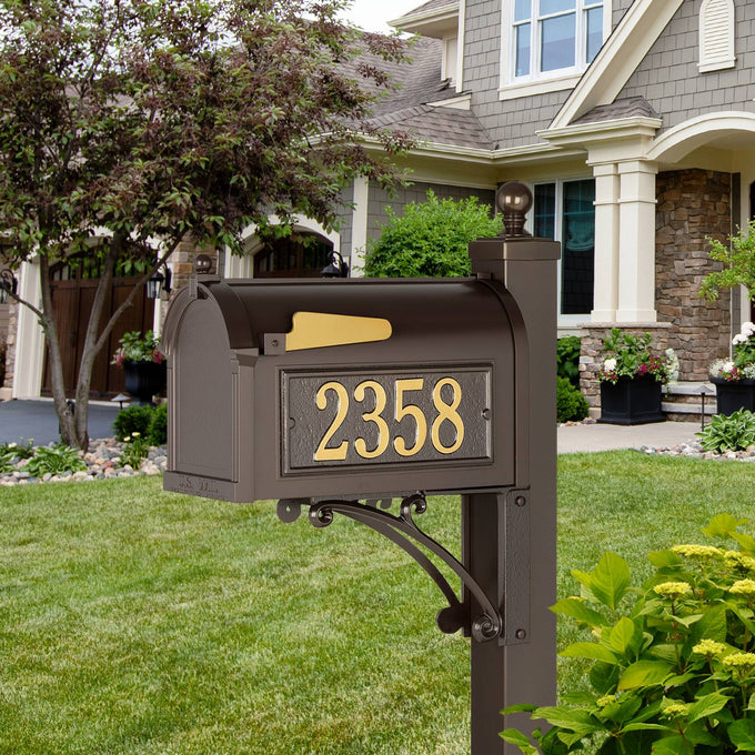 Handcrafted bronze and gold mailbox with bold street numbers mounted on a decorative post, enhancing curb appeal, made in USA for Home & Decor and Mailboxes and Address Signs collections.