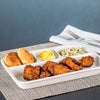 Porcelain divided tray set with crispy fried chicken, two golden biscuits, mustard condiment, and a side of coleslaw, styled on woven placemat for Kitchen & Food and Dinnerware collections.