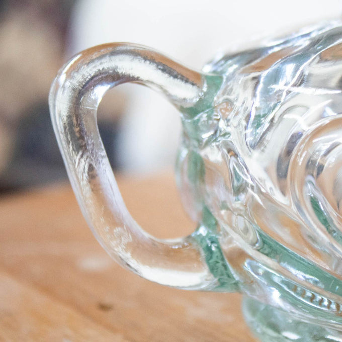 Close-up of a clear glass finger hold on a handcrafted oil lamp font, part of lamps & lighting, oil lamps, table lamps, best sellers, and promo eligible collections.