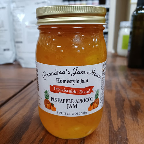 Handcrafted jar of pineapple-apricot homestyle jam with gold lid and white label featuring fruit illustrations and "Irresistable Taste" banner, made in USA, ideal for Kitchen & Food, Pantry, Peanut Butter & Jellies, Best Sellers, and Promo Eligible collections.