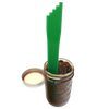 Green plastic canning bubble popper tool standing upright inside a glass jar filled with dark preserves, next to an open metal jar lid, for Kitchen & Food and Food Preservation collections.