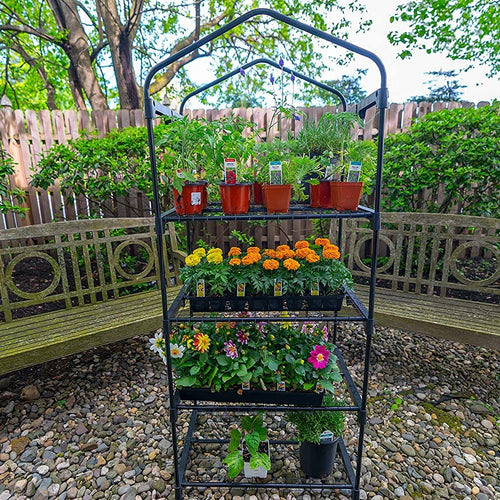 Compact greenhouse with four wire grid shelves holding various potted plants and flowers, ideal for small spaces and promoting air circulation, featured in Farm, Garden & Tool and Garden Accessories collections.