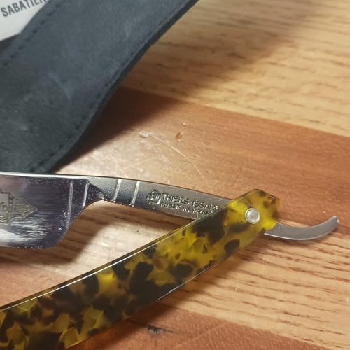 Straight razor with a tortoiseshell-patterned handle and polished steel blade, handcrafted for a precise shave, featured in Health & Wellness, Grooming and Personal Hygiene, Best Sellers, and Promo Eligible collections.