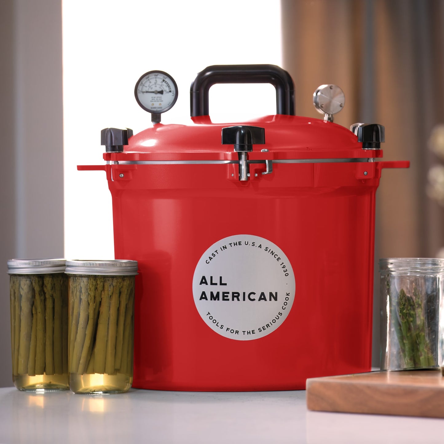 Bright red pressure canner with secure locking lid, built-in pressure gauges, and sturdy handle, designed for safe food preservation in Kitchen & Food, Canning, and USA Made collections.